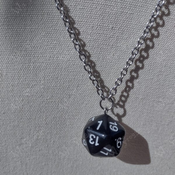 black, 20-sided die on a silver-coloured chain